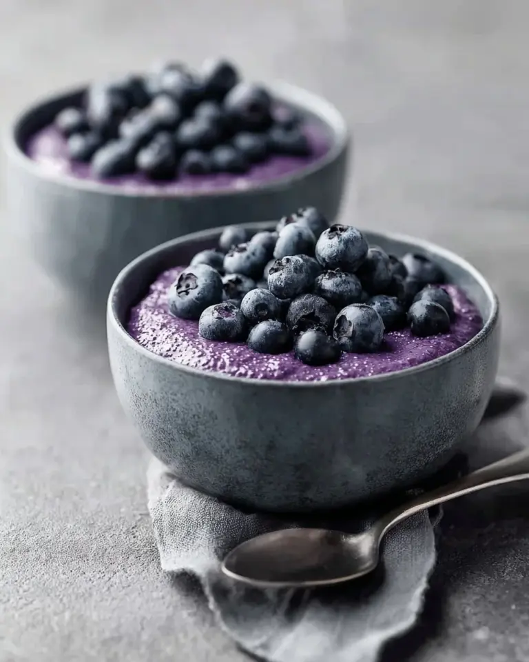 Chia seed pudding topped with fresh blueberries in a glass bowl