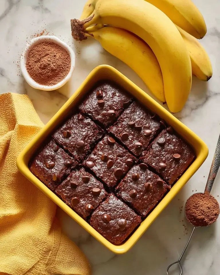 Delicious chocolate banana cake topped with chocolate ganache and banana slices.