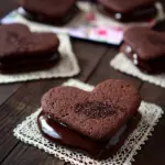 Delicious Chocolate Fudge Sandwich Cookies stacked on a plate