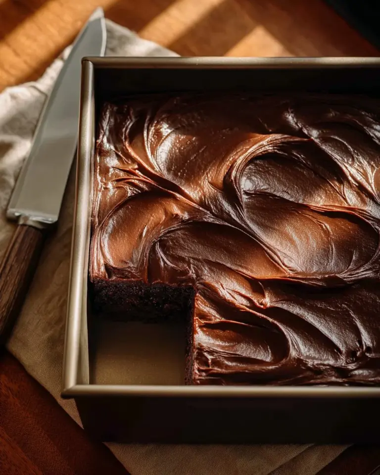 Delicious double fudge whiskey cake topped with chocolate ganache and whiskey glaze