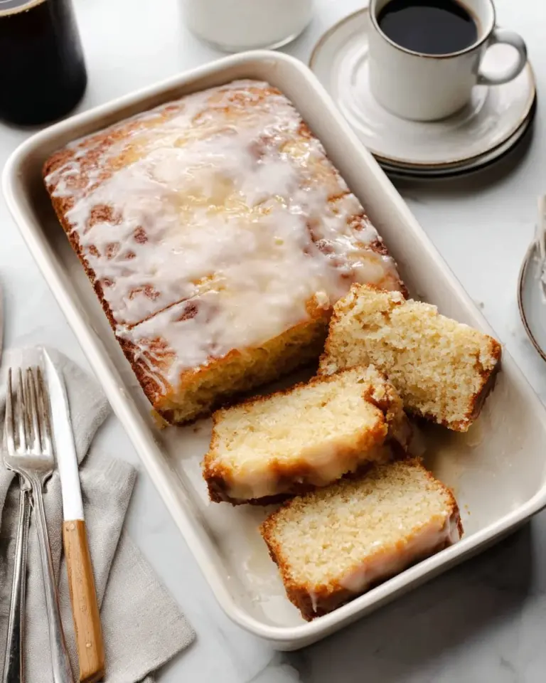 Delicious easy honey bun cake with sweet glaze on top served on a plate.