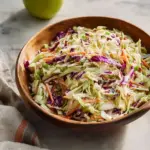 Homemade coleslaw with apple and yogurt dressing in a bowl