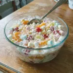 Bowl of colorful Ambrosia Fruit Salad with mixed fruits and marshmallows